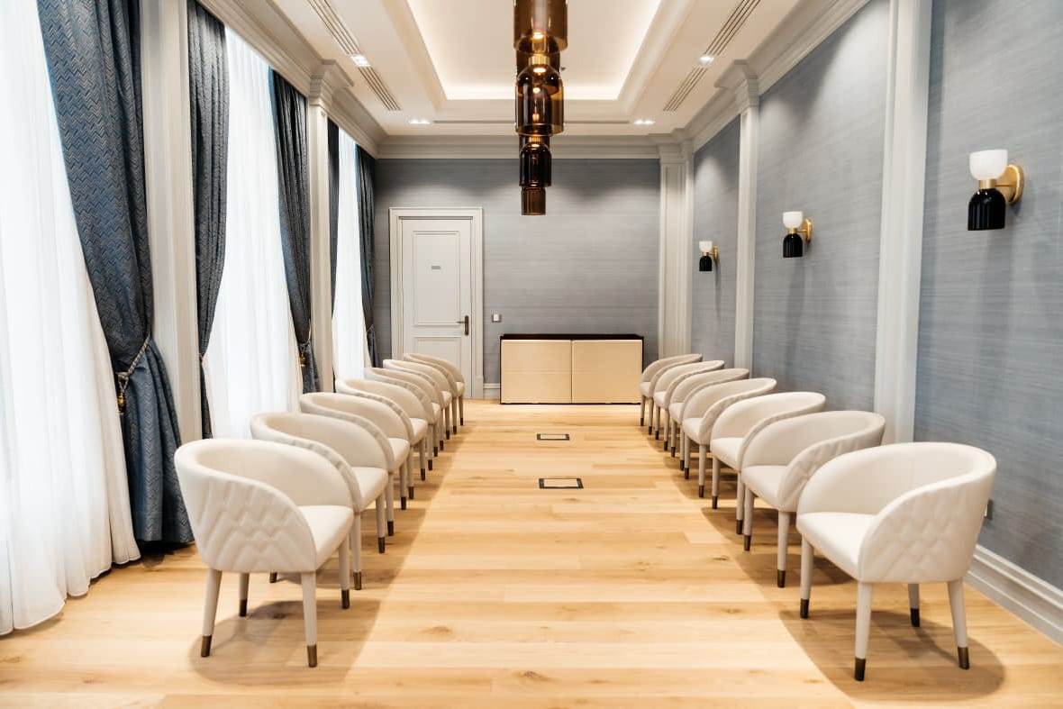Private Bank — conference — long table, cream chairs