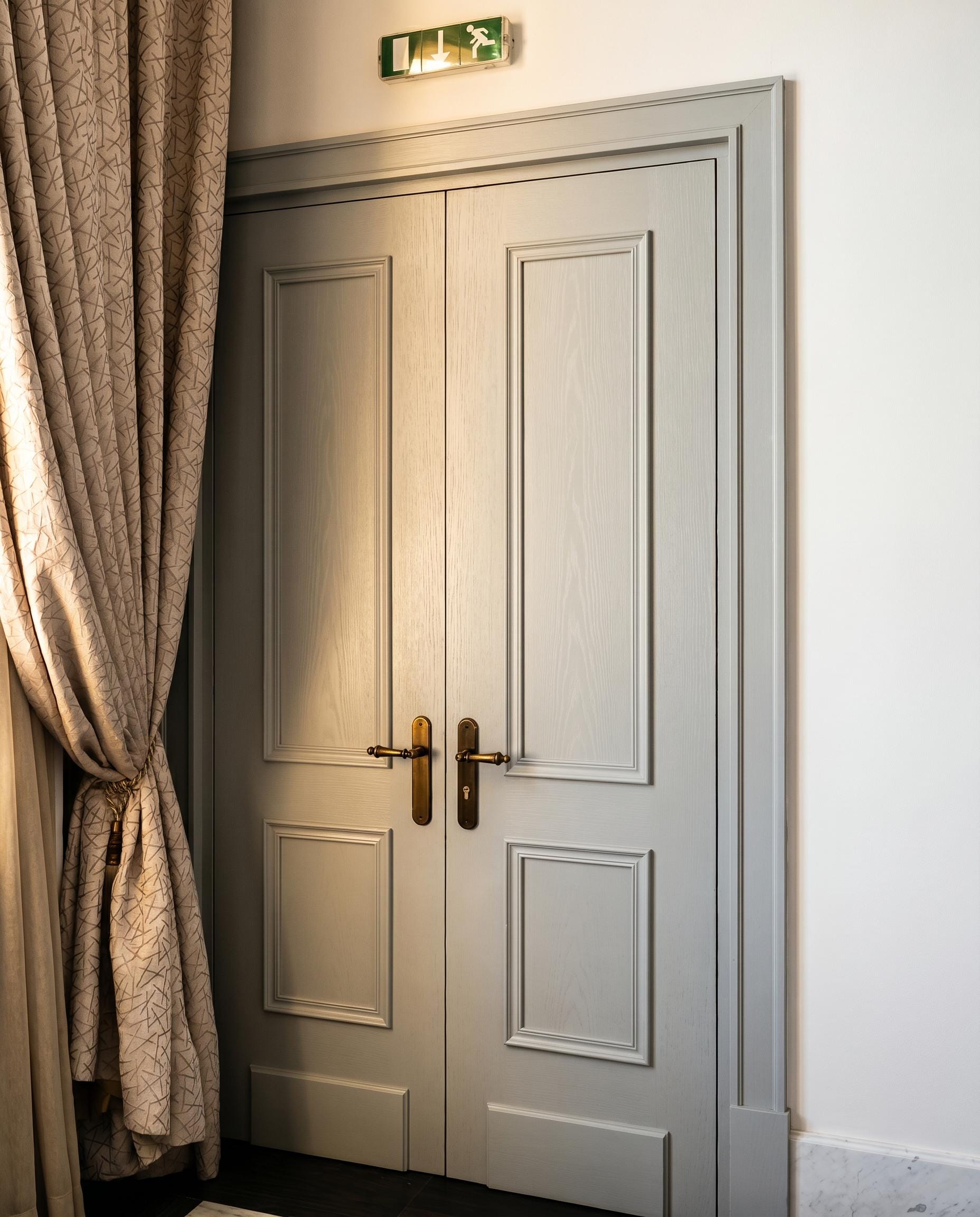 Private Bank — cream curtain, door and exit sign