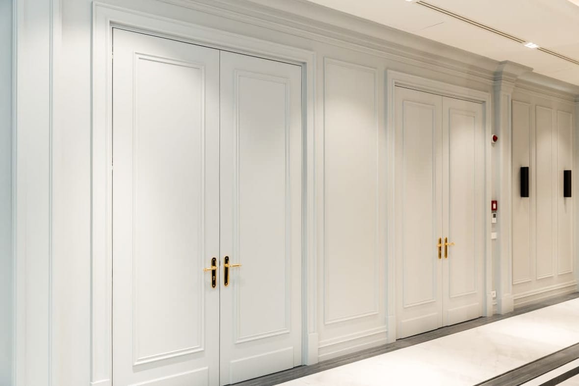 Private Bank — corridor — panelled doors, brass handles