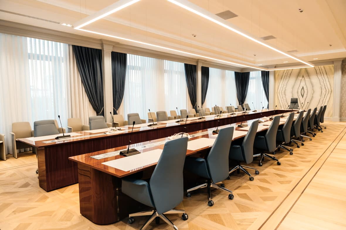 Private Bank — boardroom — dark timber table, blue chairs
